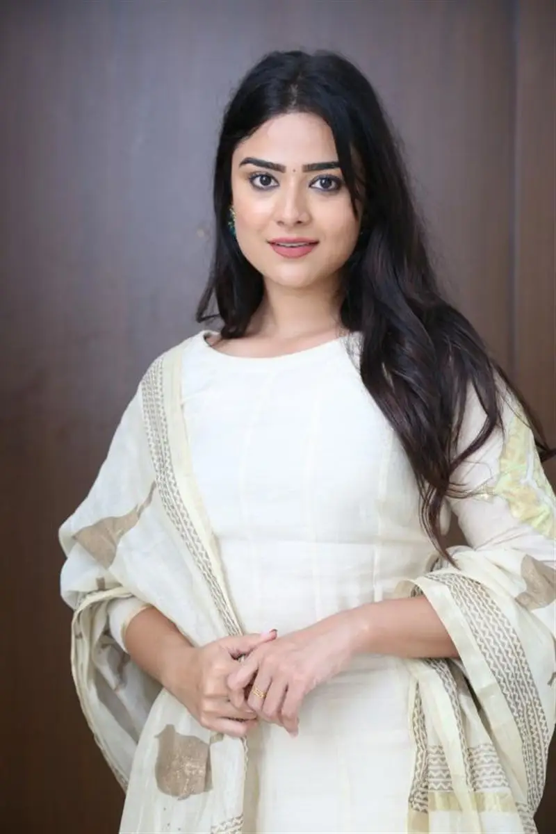 Telugu Actress Priyanka Sharma Smiling Stills in White Dress